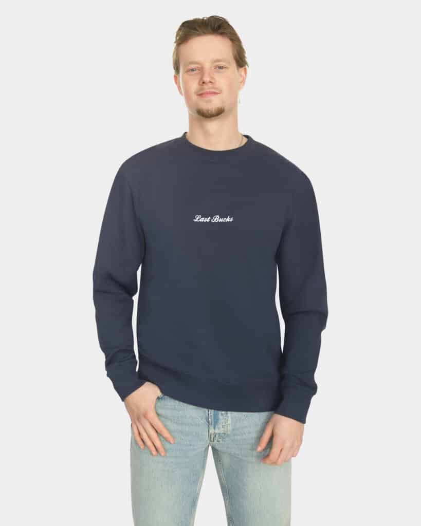 Model wearing the Last Bucks The Signature Sweater in Navy, front view