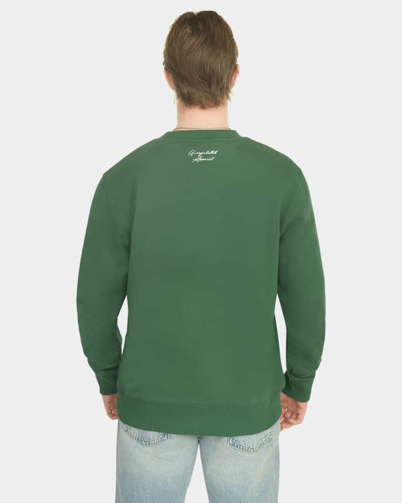 Model wearing the Last Bucks The Signature Sweater in Hunter Green, back view with knitted neck logo