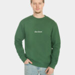 Model wearing the Last Bucks The Signature Sweater in Hunter Green, front view