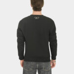 Model wearing the Last Bucks The Signature Sweater in Jet Black, back view with knitted neck logo