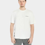 Male model wearing The Balance Side Tee in white, front view, with a small “LAST BUCKS” chest logo and a clean oversized fit