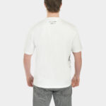 Male model wearing The Balance Side Tee in white, back view, with a small “Unregulated Apparel” script at the back neck and a clean relaxed fit