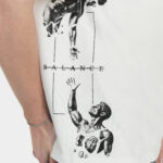 Close-up side view of The Balance Side Tee in white on a male model, featuring a vertical “BALANCE” graphic with two figures and linework printed along the side panel