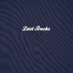 Close-up of the Last Bucks logo embroidery on The Signature Sweater in Navy