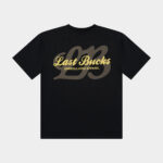 The Script Tee Jet Black - Black t-shirt back view with a large “Last Bucks” script logo in gold, “UNREGULATED APPAREL” text, and an oversized tonal “LB” graphic behind it
