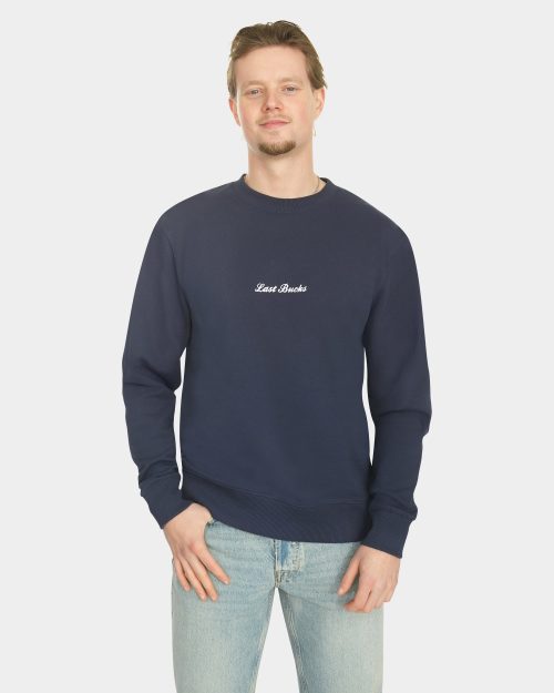 Model wearing the Last Bucks The Signature Sweater in Navy, front view
