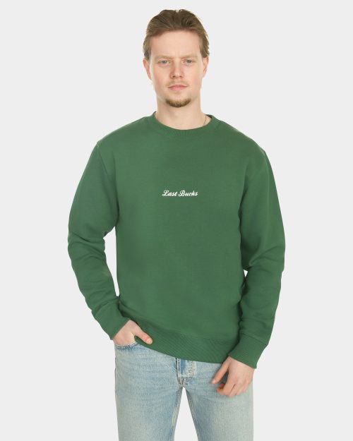 Model wearing the Last Bucks The Signature Sweater in Hunter Green, front view