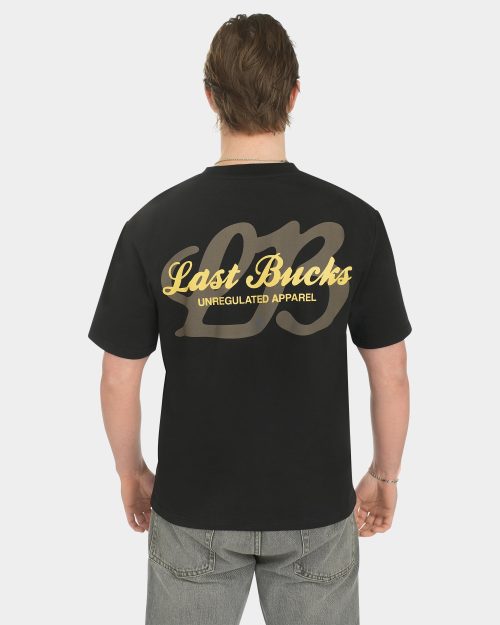 Male model wearing the Script Tee in Jet Black, back view, featuring a large gold “Last Bucks” script print with “Unregulated Apparel” and a big “LB” graphic