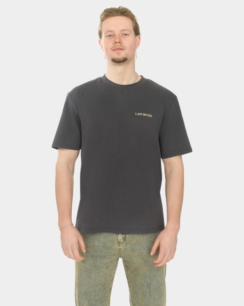 Male model wearing the In Balance Tee in Anthracite, featuring a minimalist LAST BUCKS chest logo and a relaxed fit