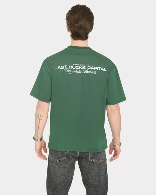 Male model wearing The Capital Tee in Hunter Green from the back with “LAST BUCKS CAPITAL” back print
