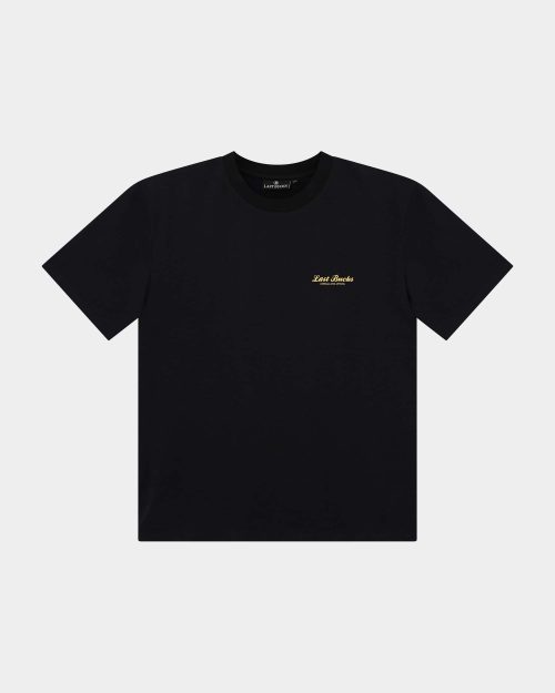 The Script Tee Jet Black - Black t-shirt front view with a small gold “Last Bucks” script logo on the left chest