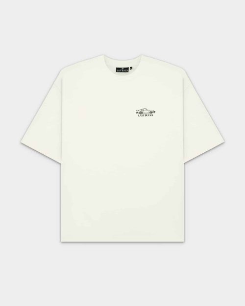 The Iconic Tee Off-White by Last Bucks, front view with a small car graphic and “LAST BUCKS” on the chest